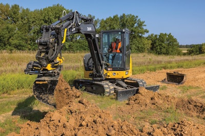 John Deere 60G compact excavator digging in dirt with Engcon tiltrotator bucket